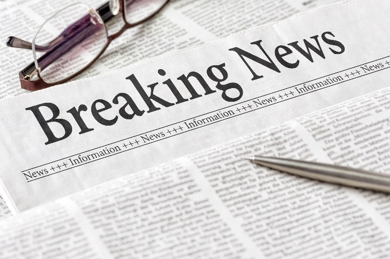 Newspaper with breaking news text